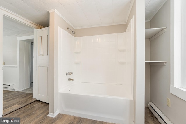 bathroom featuring wood finished floors, a baseboard radiator, ornamental molding, shower / bathing tub combination, and baseboard heating