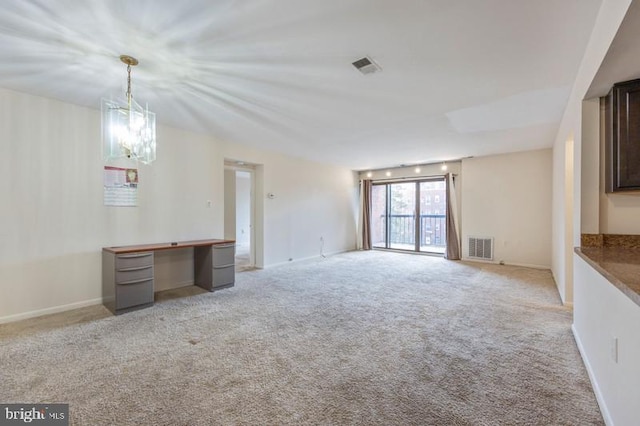 6711 Park Heights Ave Unit 207, Baltimore, MD 21215 - unfurnished living room featuring light carpet and a chandelier