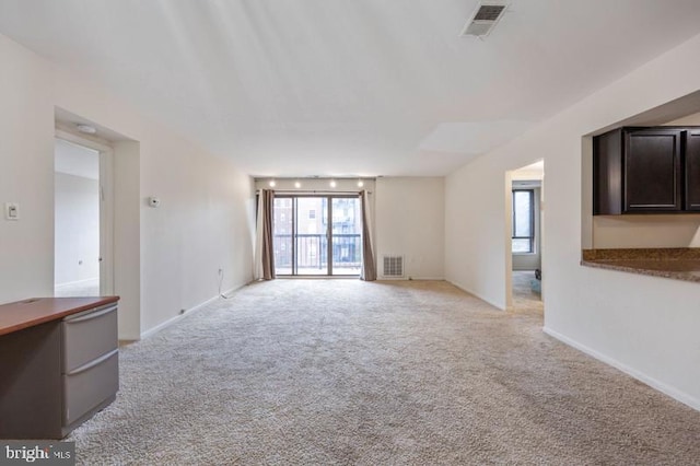 6711 Park Heights Ave Unit 207, Baltimore, MD 21215 - unfurnished living room with light colored carpet and baseboards