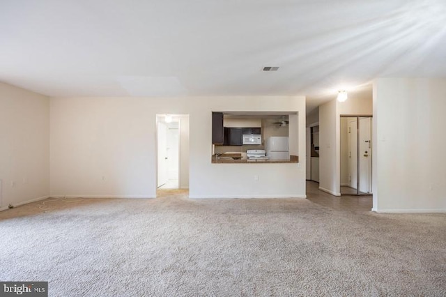 6711 Park Heights Ave Unit 207, Baltimore, MD 21215 - unfurnished living room with carpet floors and baseboards