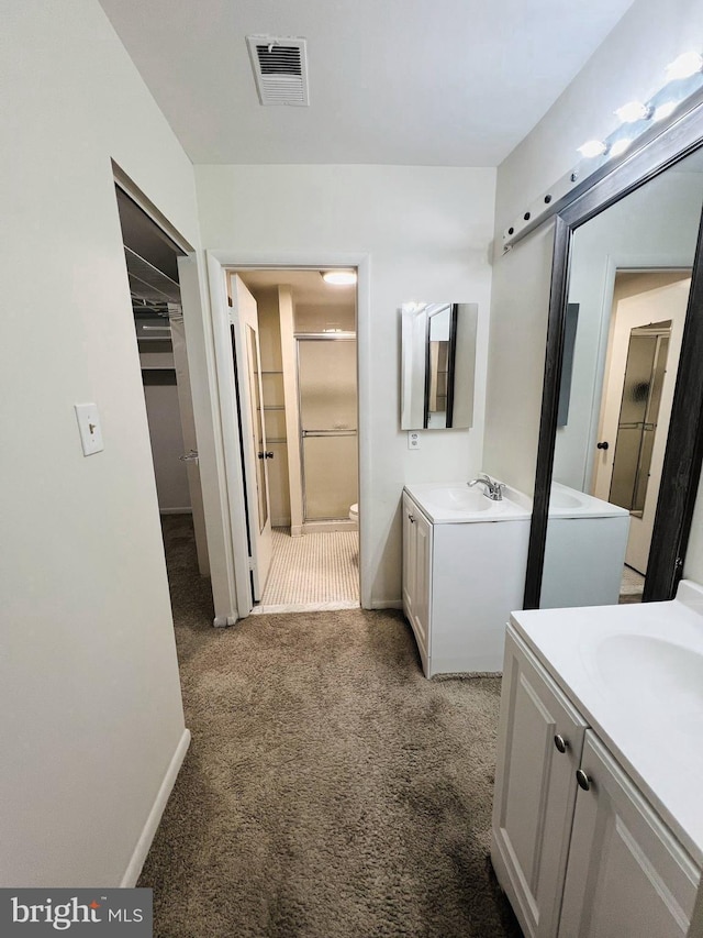 6711 Park Heights Ave Unit 207, Baltimore, MD 21215 - bathroom with two vanities and a stall shower