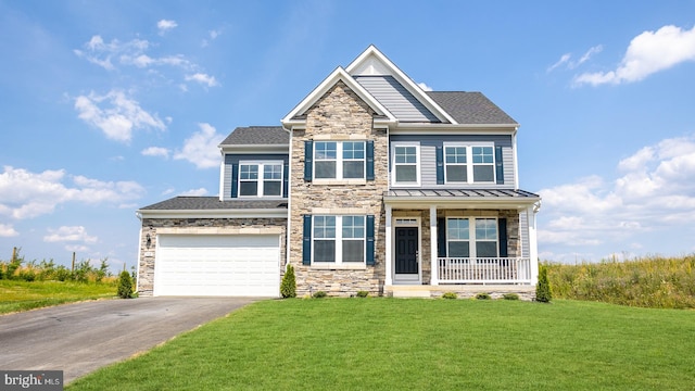 view of front of house featuring a porch, a front yard, and a garage