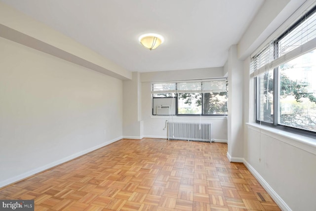 empty room with radiator and a wealth of natural light