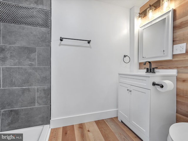 bathroom with hardwood / wood-style flooring, vanity, and toilet