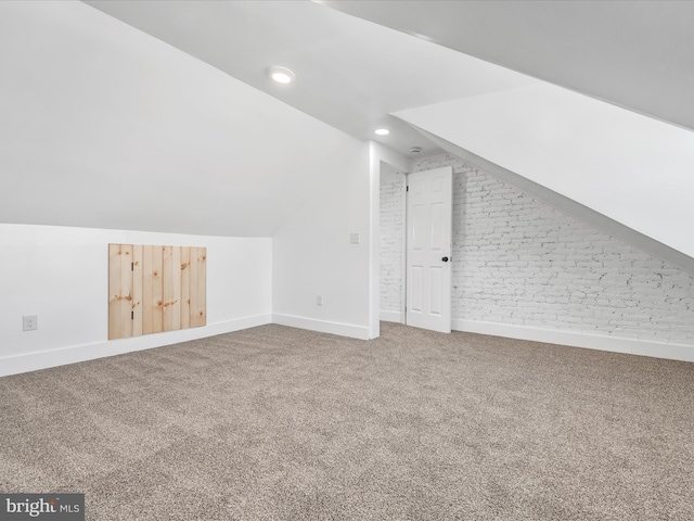 additional living space with carpet and vaulted ceiling