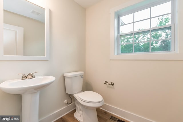 bathroom with sink, toilet, and hardwood / wood-style flooring