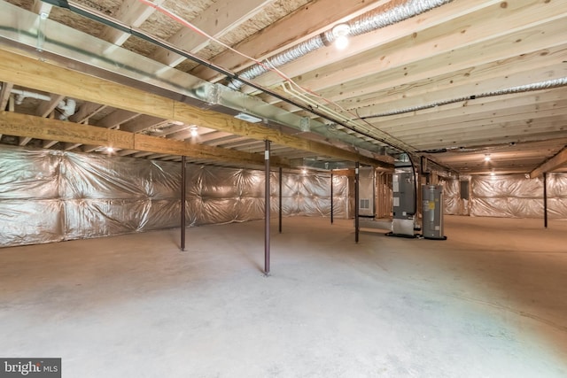 basement featuring heating unit and electric water heater