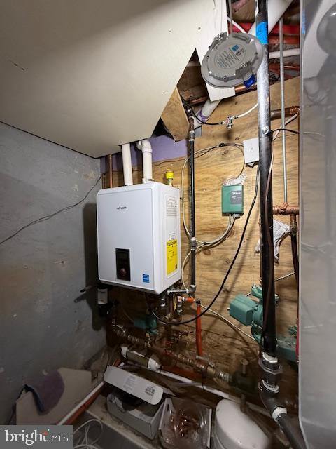 utility room featuring water heater