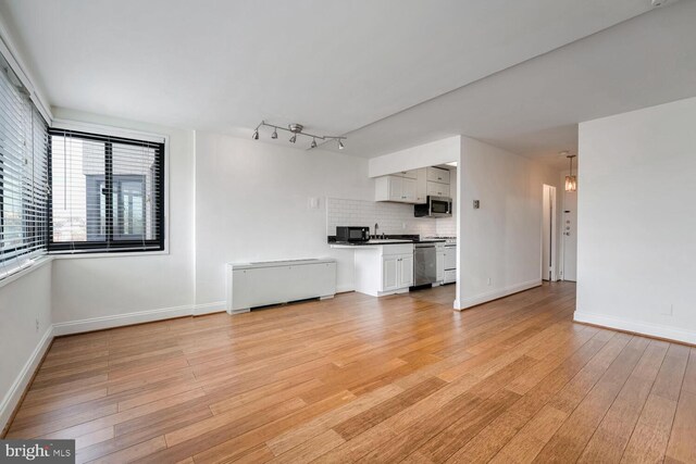 unfurnished living room featuring light hardwood / wood-style flooring