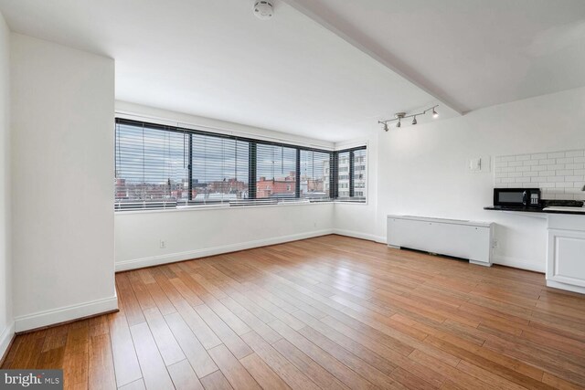 unfurnished living room with light hardwood / wood-style floors