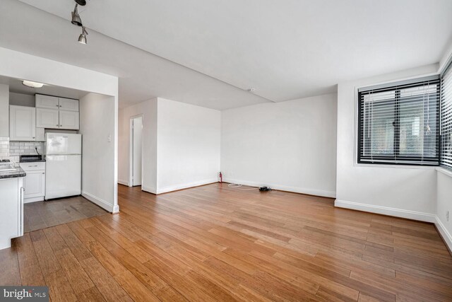 unfurnished living room featuring light hardwood / wood-style floors