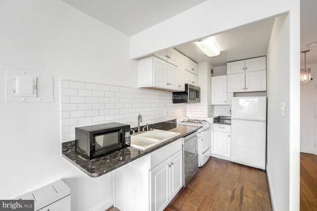 kitchen featuring white cabinets, sink, tasteful backsplash, dark hardwood / wood-style flooring, and stainless steel appliances