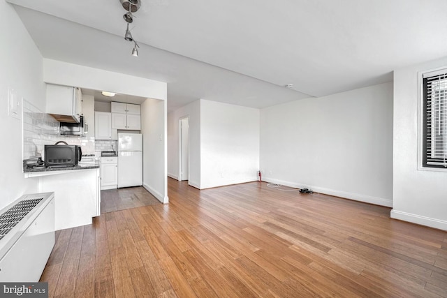 unfurnished living room with light hardwood / wood-style floors