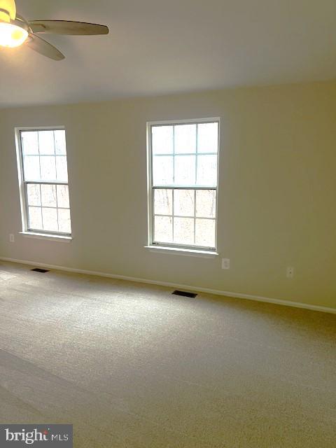 carpeted empty room with ceiling fan