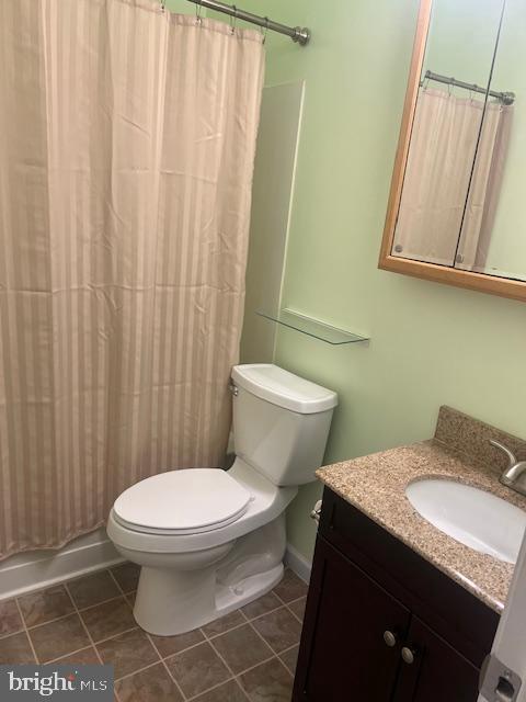 bathroom with tile patterned floors, vanity, and toilet