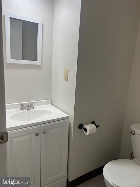 bathroom with tile patterned floors, vanity, and toilet