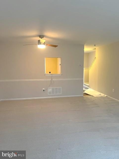 spare room with ceiling fan and carpet