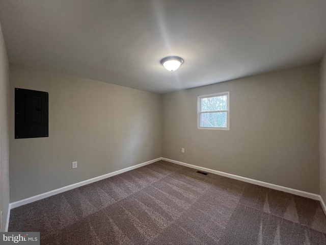 carpeted spare room featuring electric panel