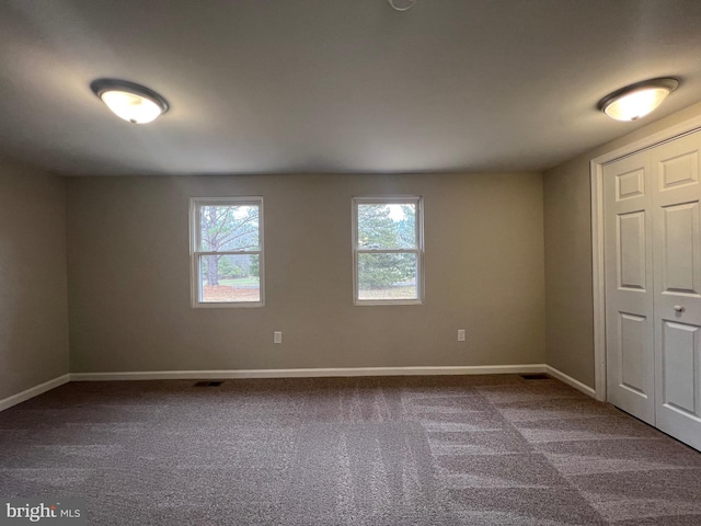 unfurnished bedroom with carpet and a closet