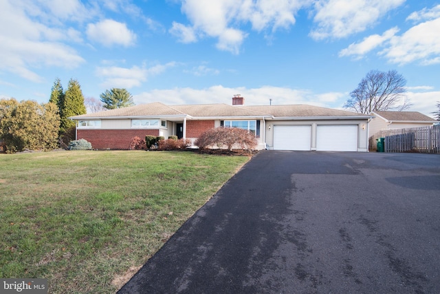 ranch-style home featuring a garage and a front lawn