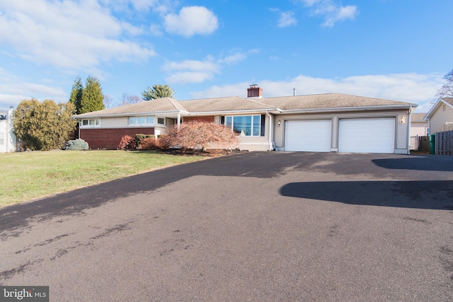 single story home with a garage and a front yard