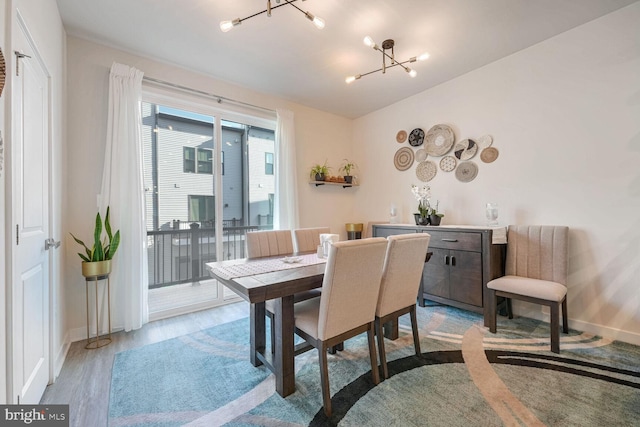 dining area featuring a chandelier and light hardwood / wood-style floors