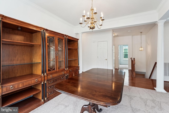 home office featuring carpet, ornamental molding, ornate columns, and an inviting chandelier