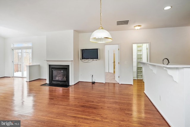 unfurnished living room with hardwood / wood-style floors