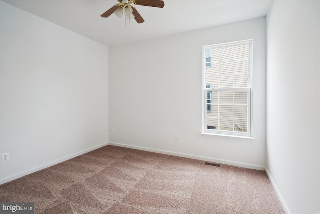 empty room featuring carpet floors and ceiling fan