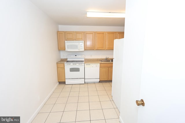 kitchen with white appliances, light tile patterned floors, sink, and light brown cabinets