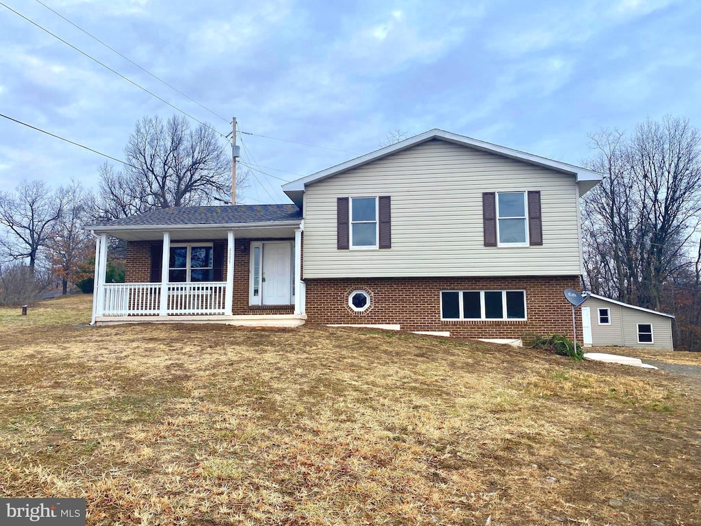 split level home featuring a front lawn and a porch