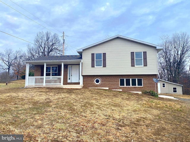 split level home featuring a front lawn and a porch