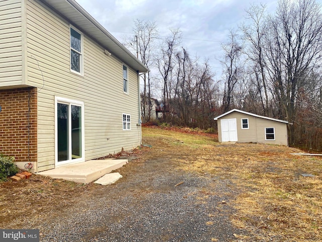 view of home's exterior with a storage unit