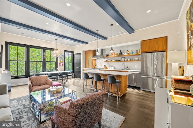 interior space featuring beam ceiling, sink, dark wood-type flooring, and a chandelier