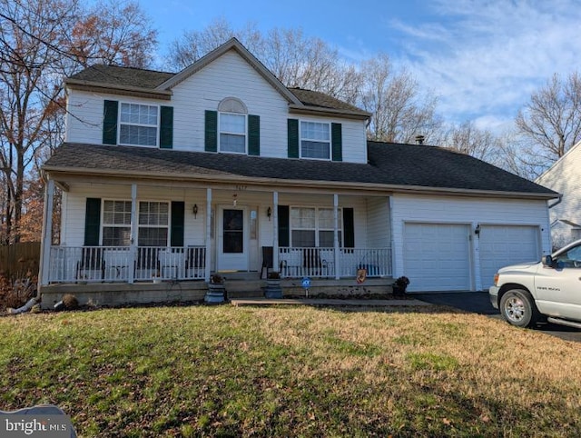 view of front of house with a porch, a garage, and a front yard