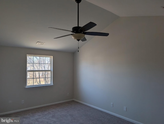 unfurnished room featuring baseboards, visible vents, a ceiling fan, vaulted ceiling, and carpet flooring