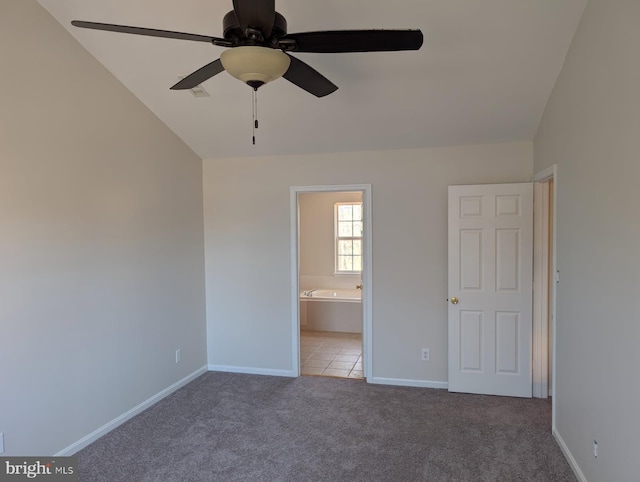 unfurnished bedroom with light carpet, ceiling fan, baseboards, and connected bathroom