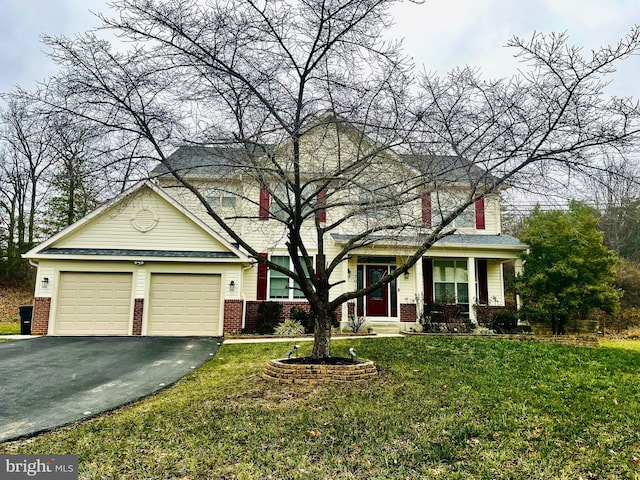 view of front property with a porch, a garage, and a front lawn