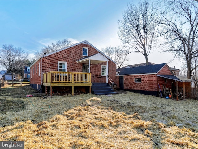 view of front of house with a wooden deck and a front lawn