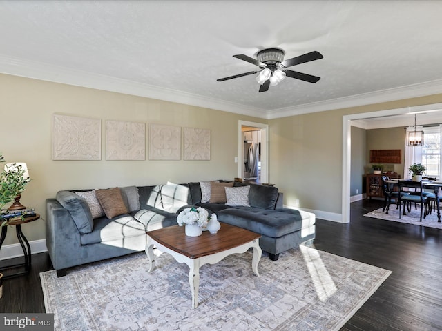 living room featuring crown molding, dark hardwood / wood-style floors, and ceiling fan