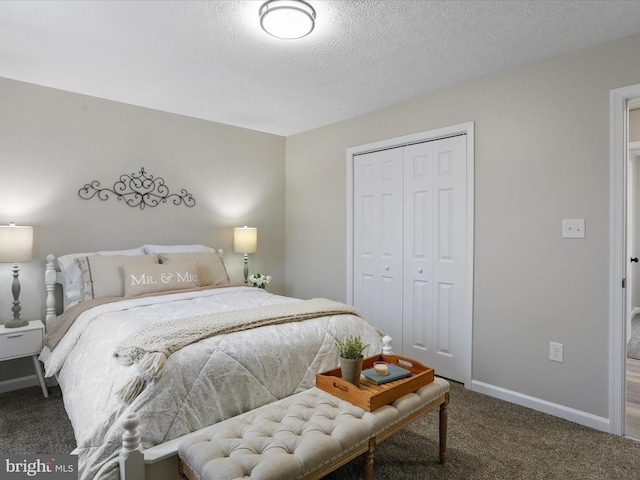 bedroom featuring a closet, a textured ceiling, and carpet