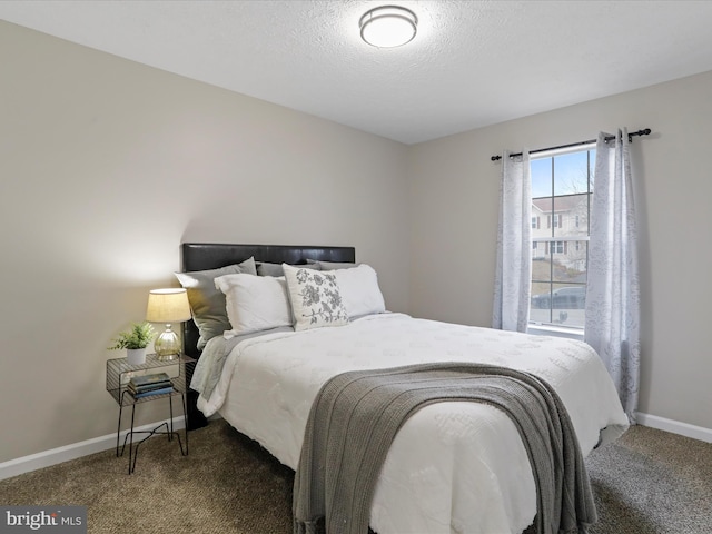 carpeted bedroom featuring a textured ceiling