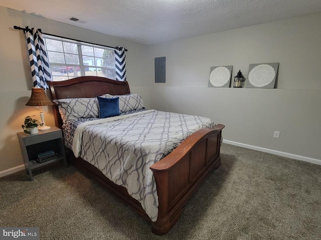 bedroom featuring a textured ceiling and dark colored carpet