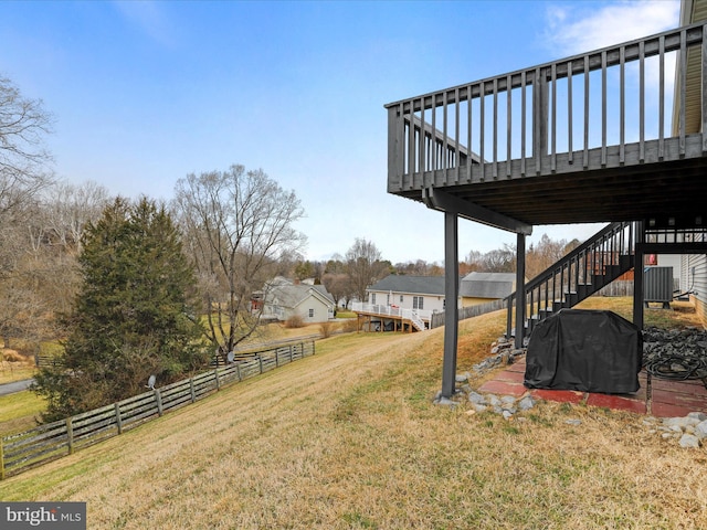 view of yard featuring central AC and a deck