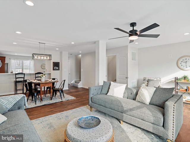 living room featuring ceiling fan and wood-type flooring