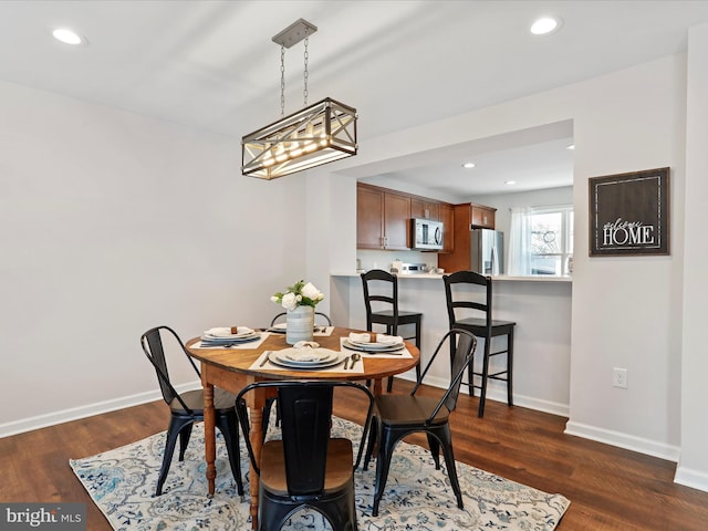 dining area with dark hardwood / wood-style flooring