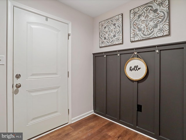 doorway with dark wood-type flooring