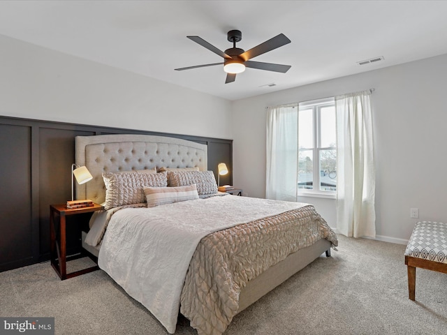 bedroom with ceiling fan and light colored carpet