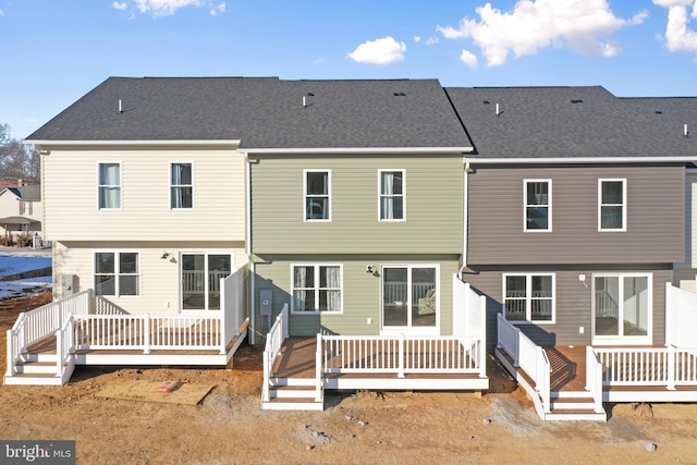 rear view of house featuring a deck