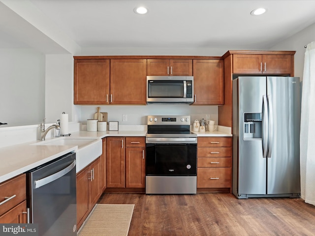 kitchen featuring appliances with stainless steel finishes, dark hardwood / wood-style floors, and sink